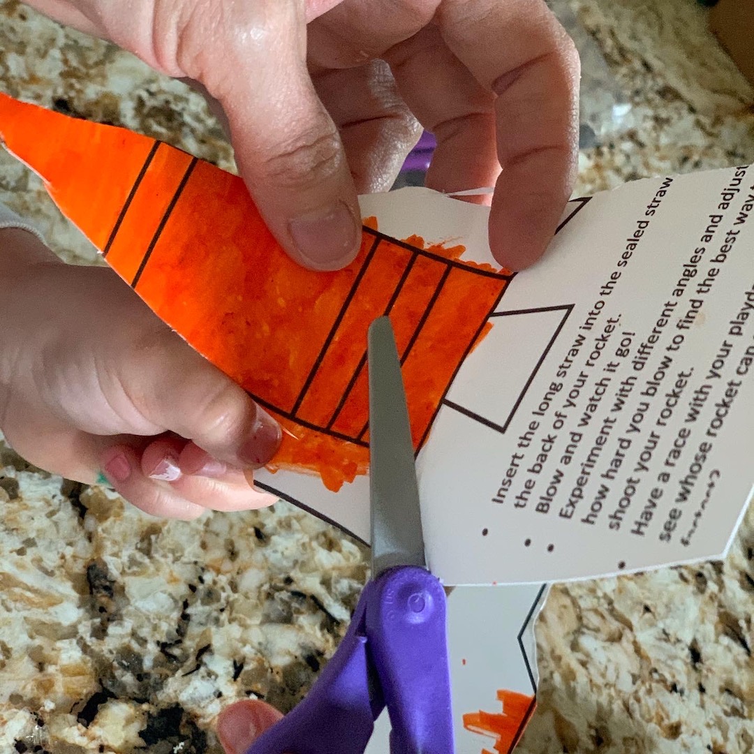 cutting out straw rocket with instructions