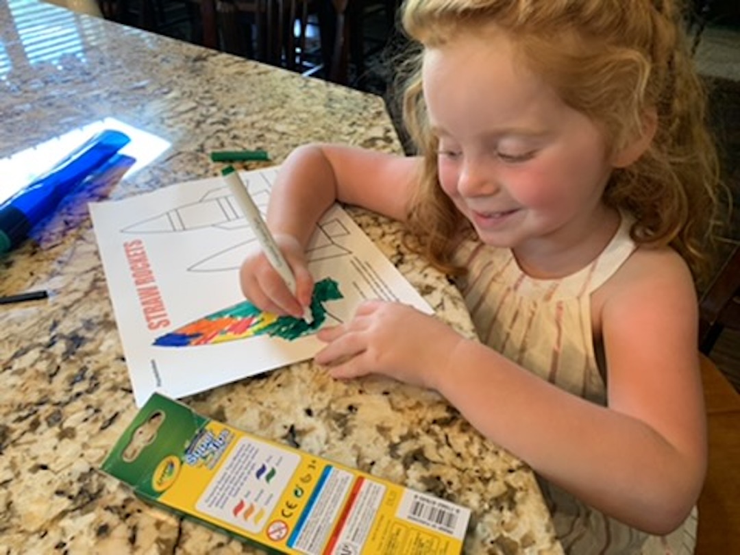 child coloring straw rocket