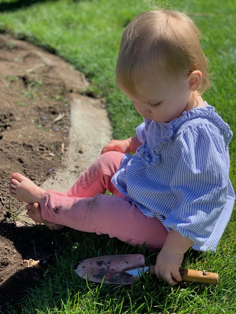 child with garden trowel