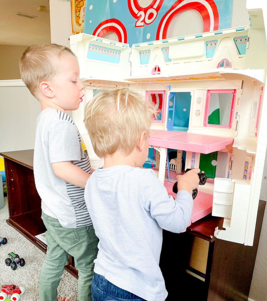 children playing with a dollhouse