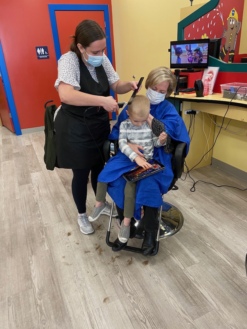 frightened toddler getting a haircut