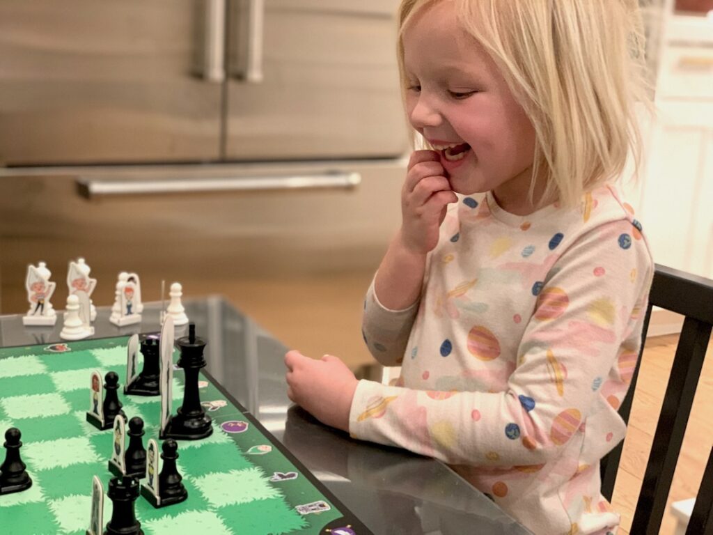 child learning to move chess pieces using Storytime Chess game