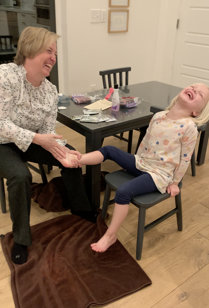 Grandpa and Grandpa Date - Grandma applying a sugar scrub to granddaughter's feet
