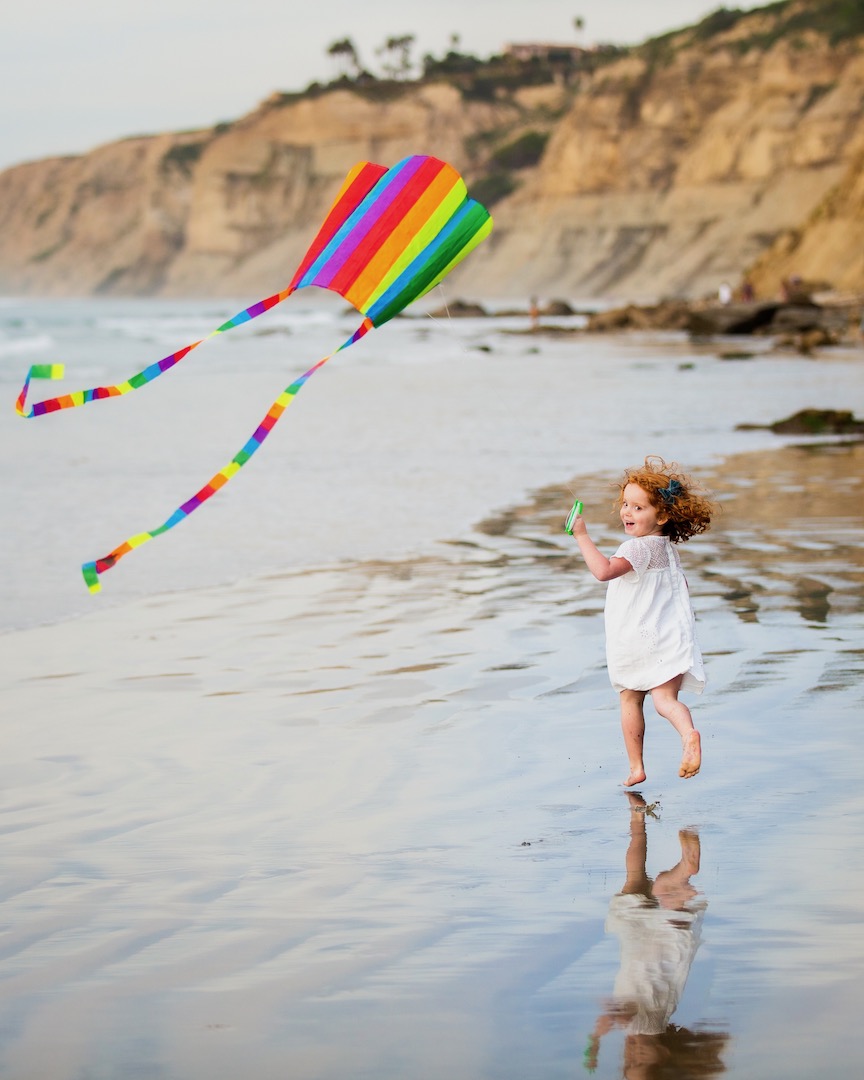 flying a kite at the beach during the extended family vacation