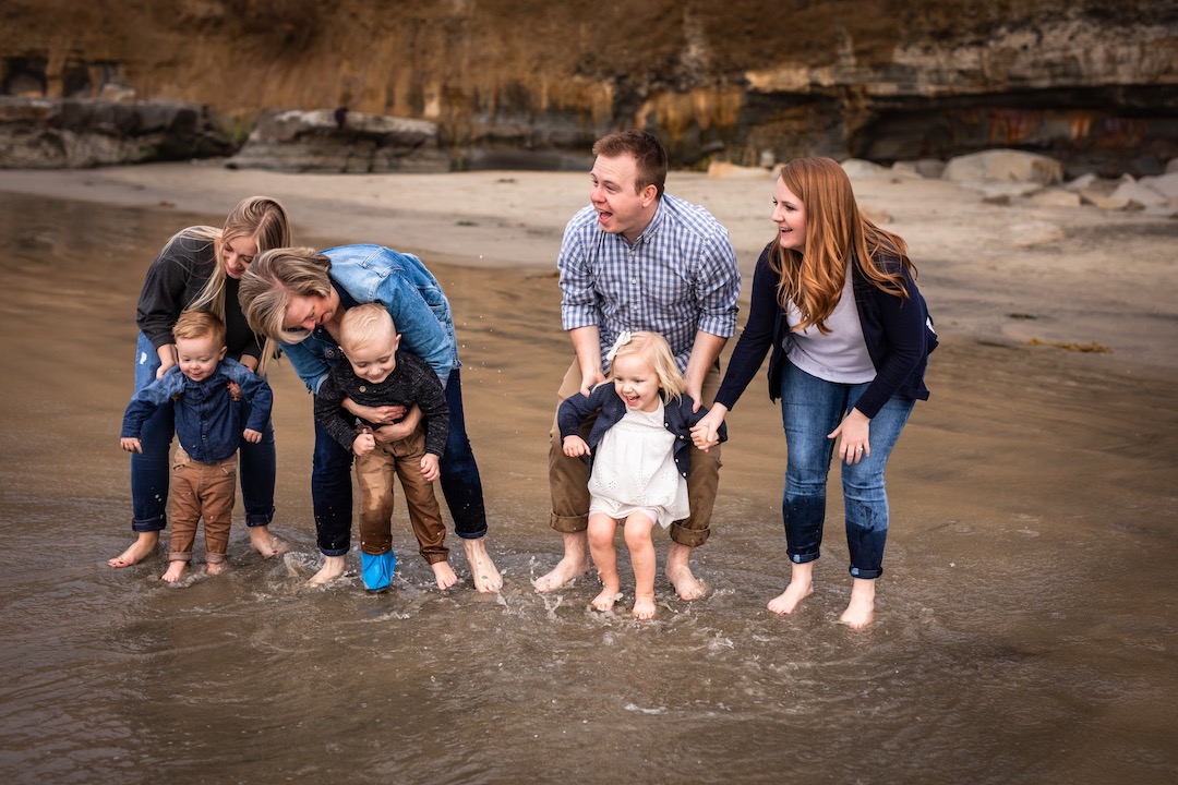 family playing in the ocean