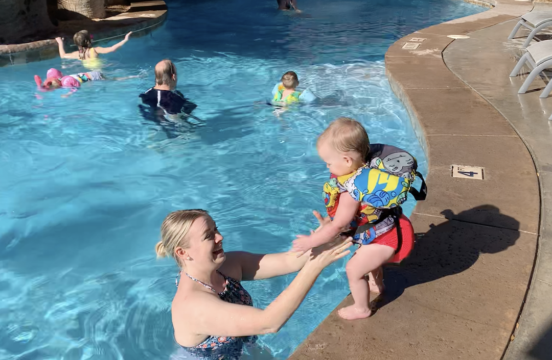 family swimming in pool