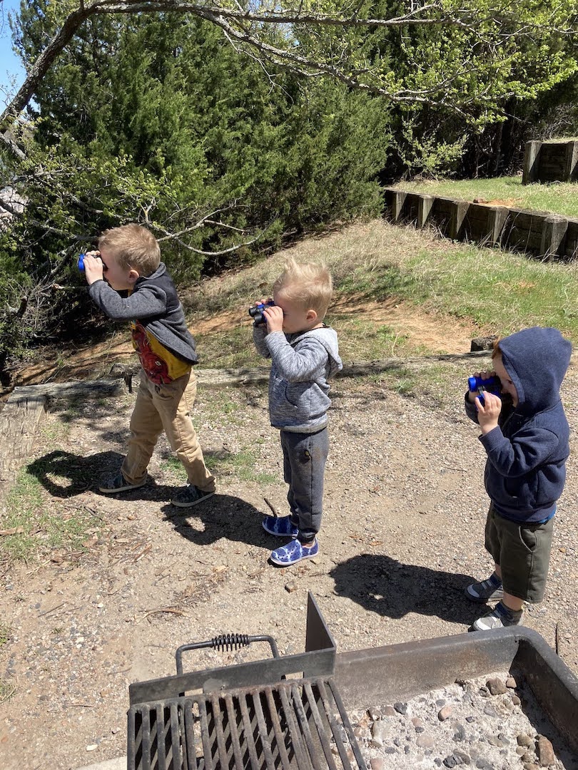 children looking through binoculars