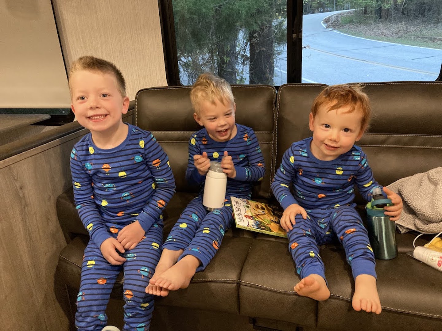3 youngsters in matching pajamas in trailer