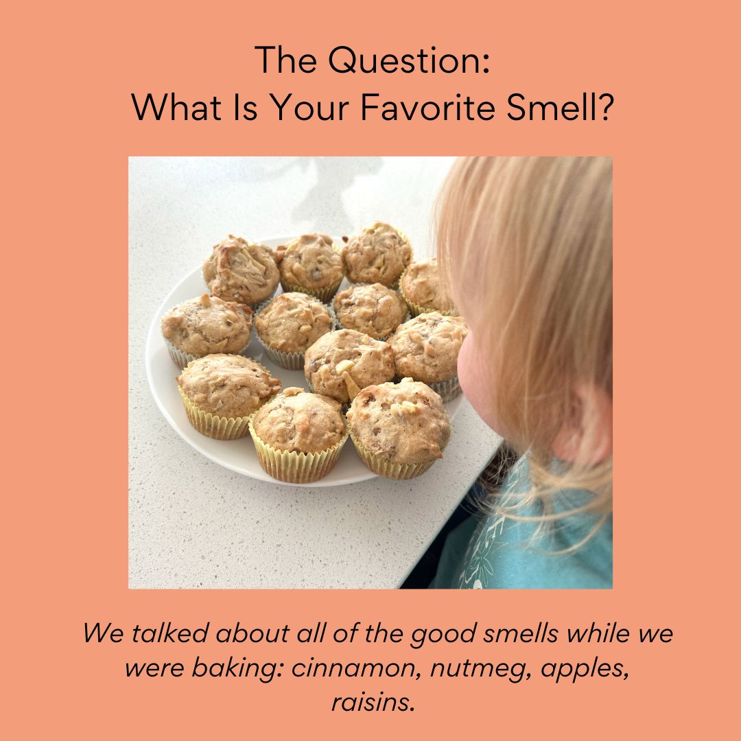 Little girl smelling finished muffins