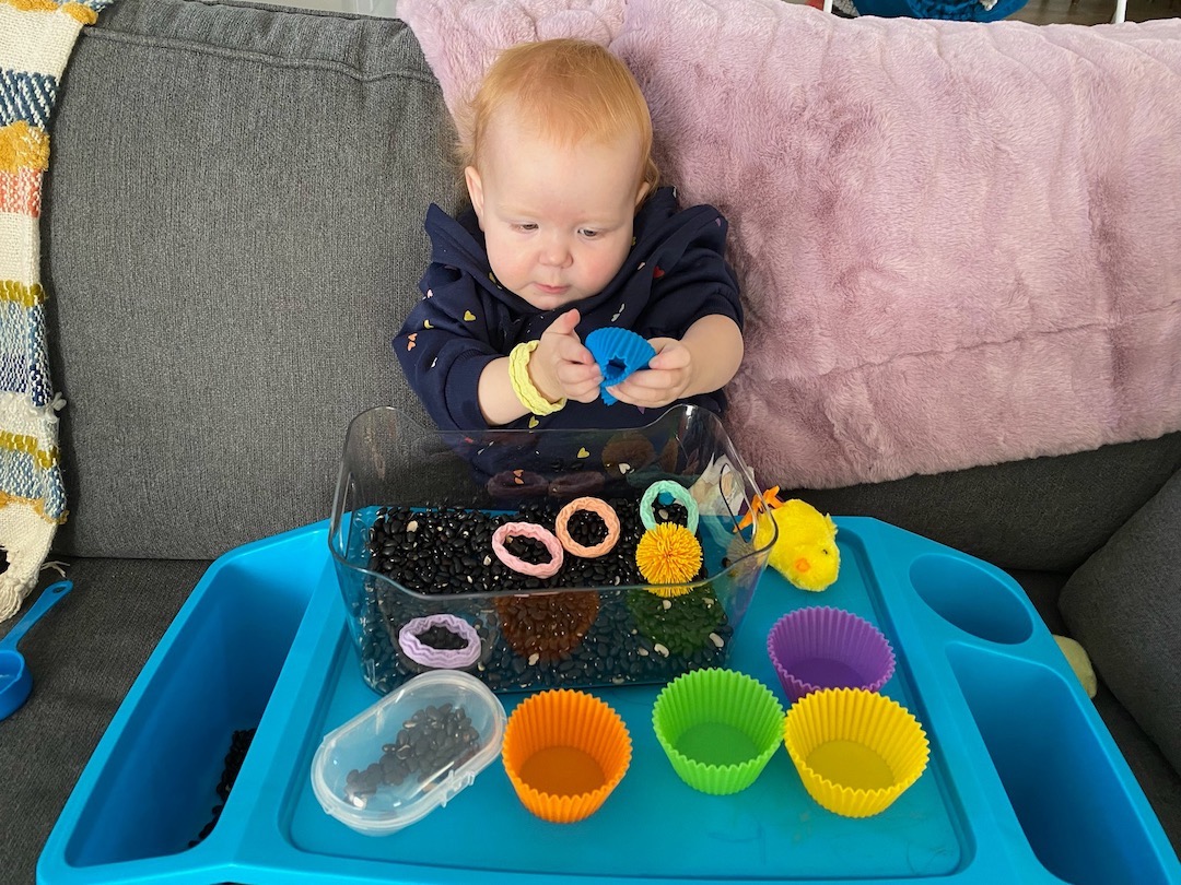 black beans and silicone toys sensory bin